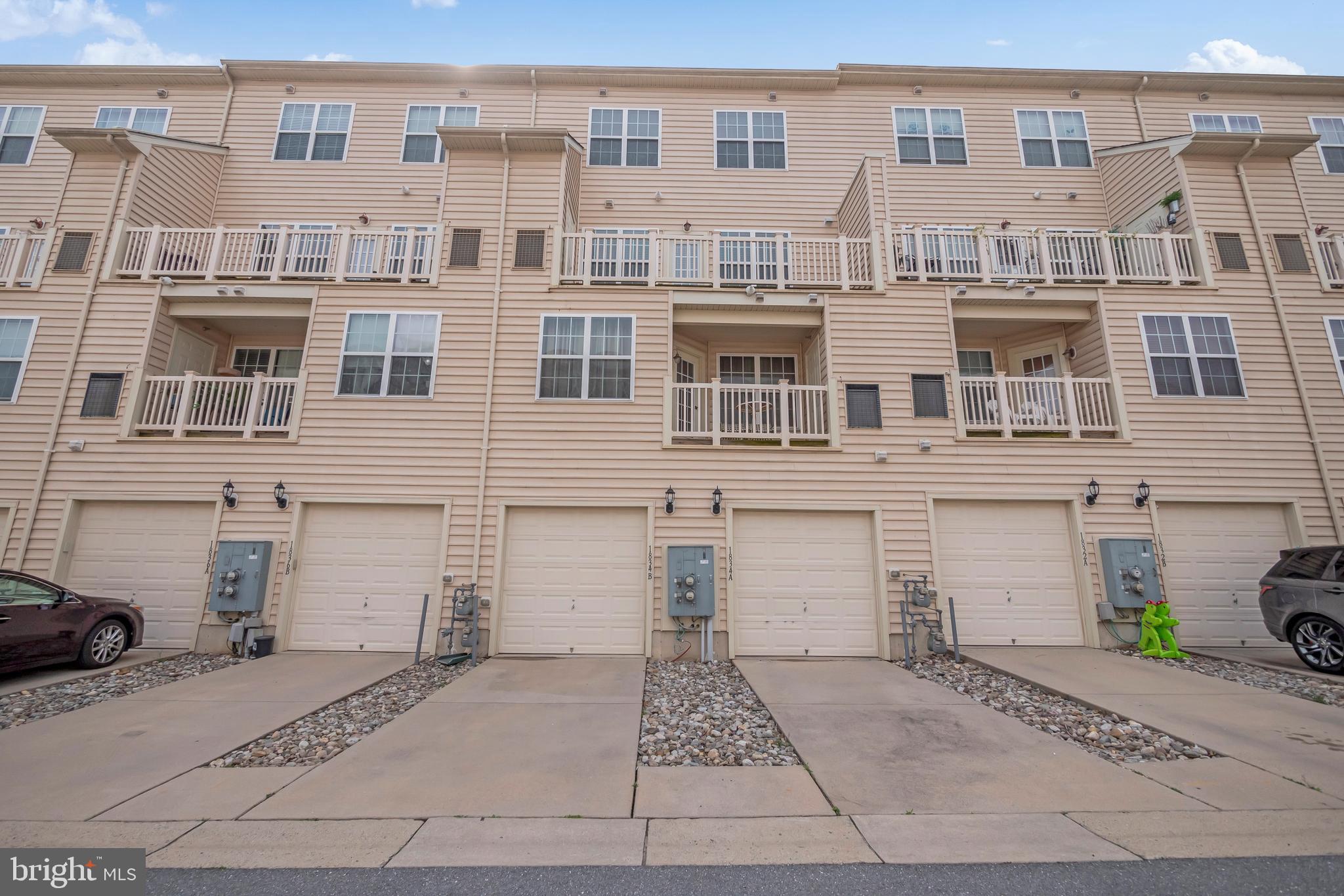 1834 Monocacy View Circle, Unit 53B Frederick, MD 21701 - Photo 27 of 30 a front view of a building with a yard and parking space