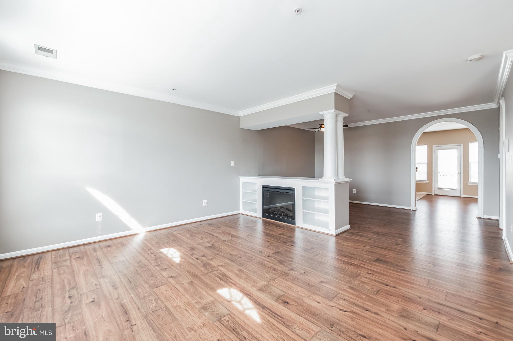 1834 Monocacy View Circle, Unit 53B Frederick, MD 21701 - Photo 3 of 30 an empty room with wooden floor fireplace and windows