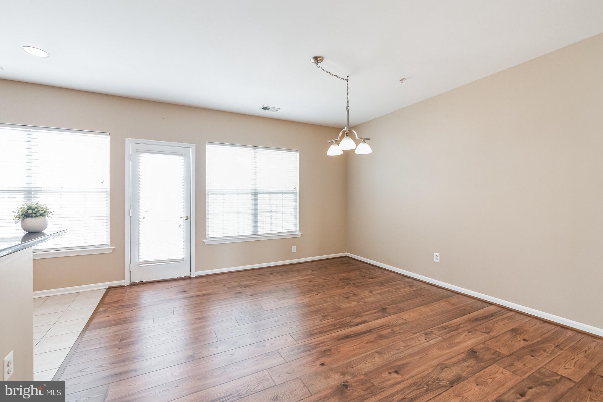 1834 Monocacy View Circle, Unit 53B Frederick, MD 21701 - Photo 8 of 30 an empty room with wooden floor and windows