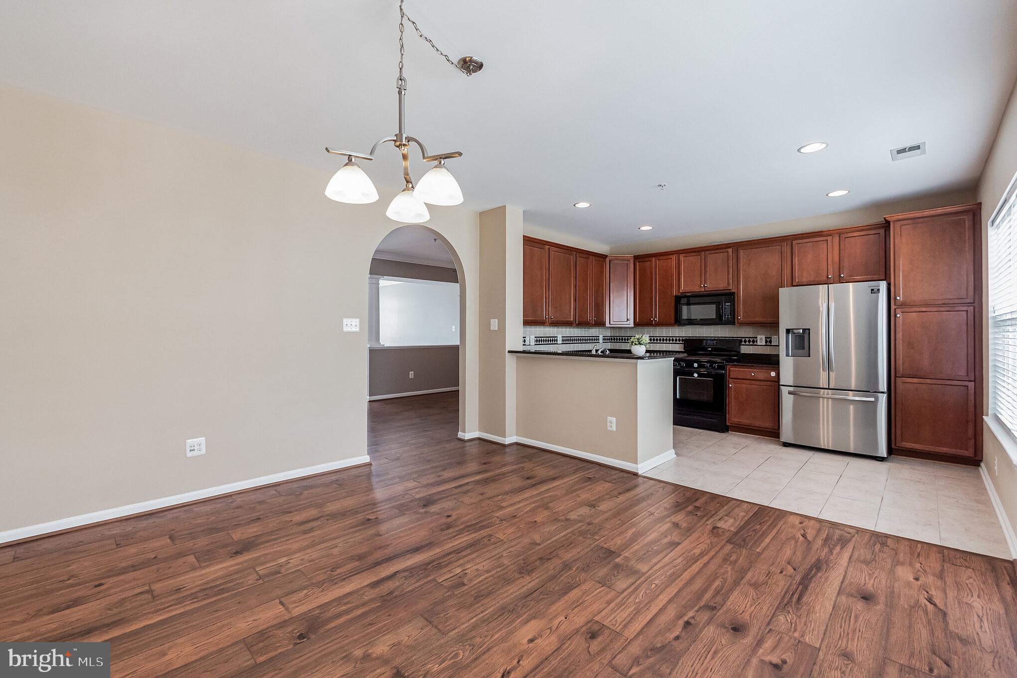 1834 Monocacy View Circle, Unit 53B Frederick, MD 21701 - Photo 9 of 30 a view of kitchen with granite countertop stainless steel appliances and wooden floor