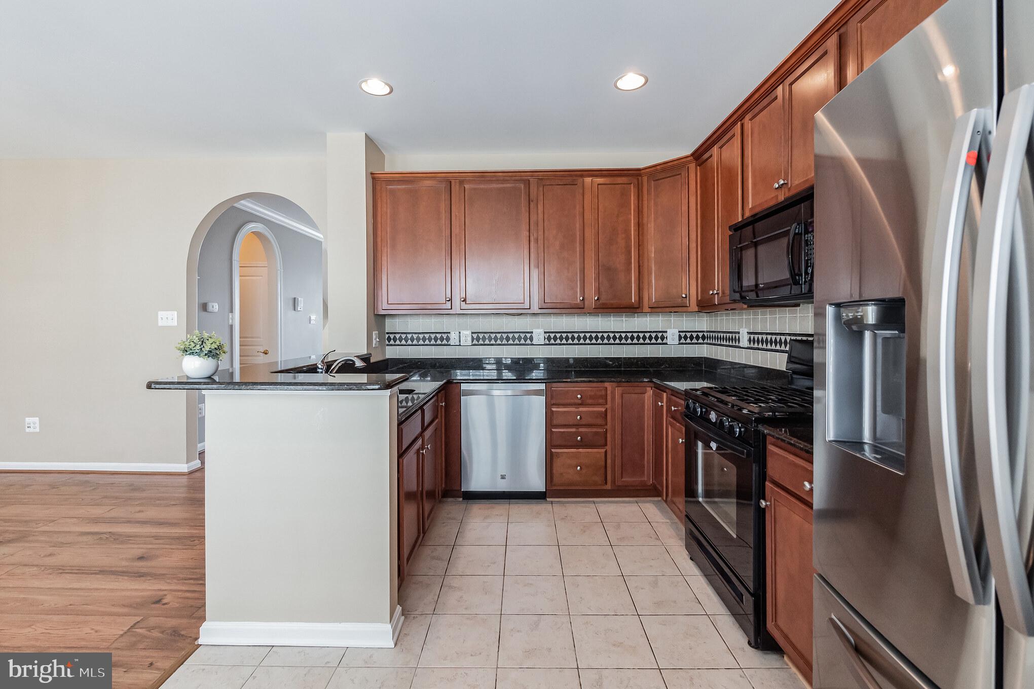 1834 Monocacy View Circle, Unit 53B Frederick, MD 21701 - Photo 10 of 30 a kitchen with stainless steel appliances granite countertop a stove a sink dishwasher and a refrigerator