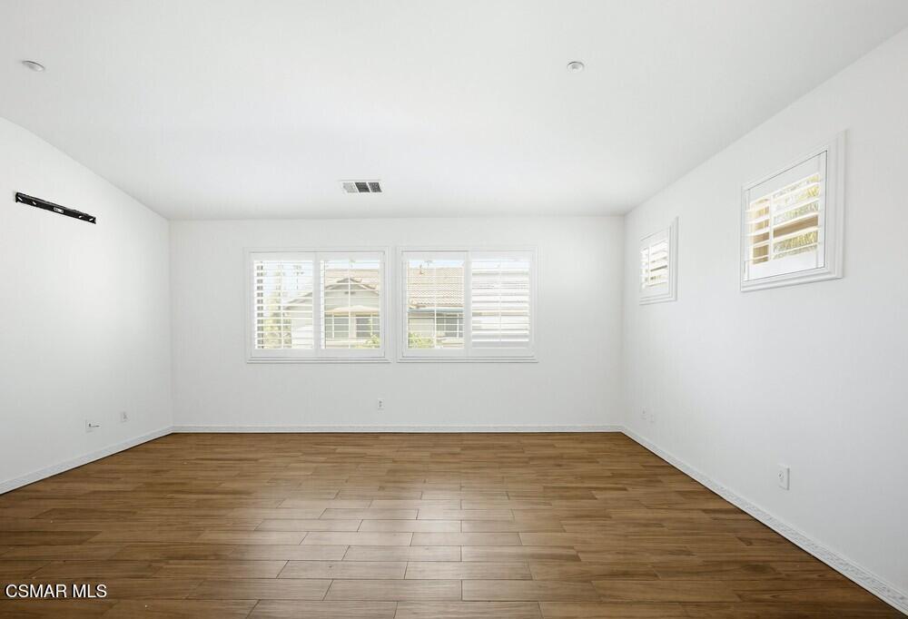 1909 Taormina Court Riverside, CA 92507 - Photo 17 of 58 wooden floor in an empty room with a window