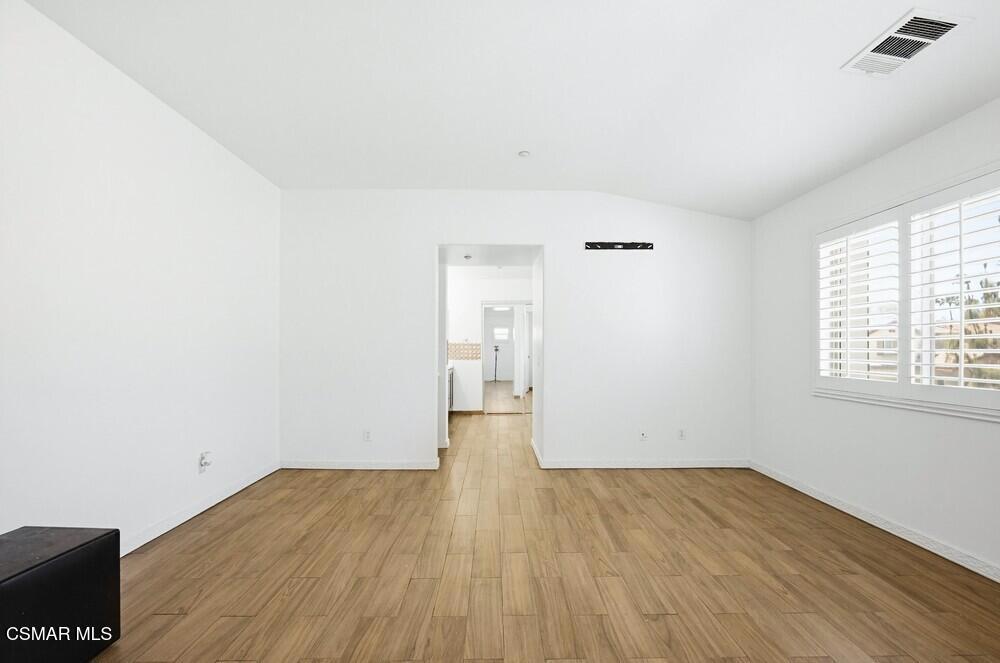 1909 Taormina Court Riverside, CA 92507 - Photo 19 of 58 an empty room with wooden floor and windows