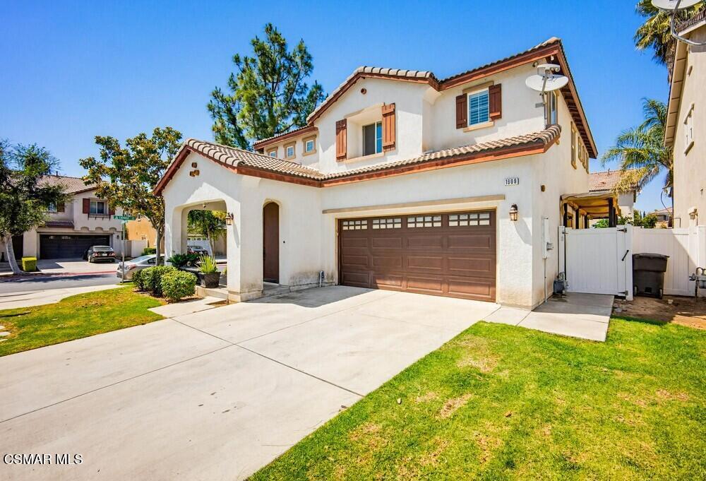 1909 Taormina Court Riverside, CA 92507 - Photo 2 of 58 a front view of a house with a yard and garage