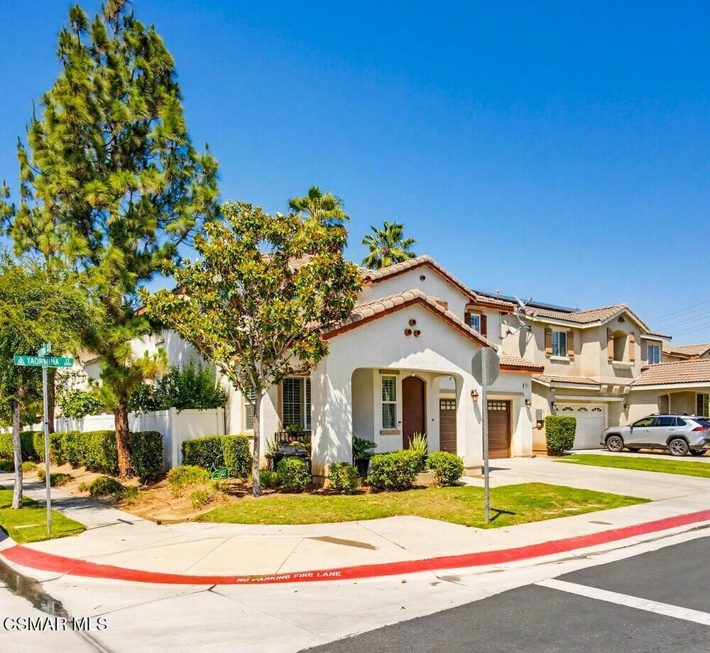 1909 Taormina Court Riverside, CA 92507 - Photo 3 of 58 a front view of a house with a yard