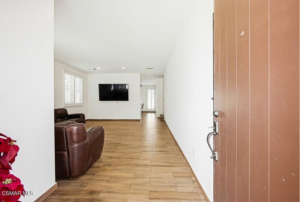 1909 Taormina Court Riverside, CA 92507 - Photo 6 of 58 a hallway with wooden floor windows and cabinet