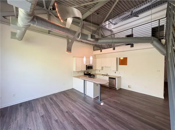 a living room with wooden floor and furniture