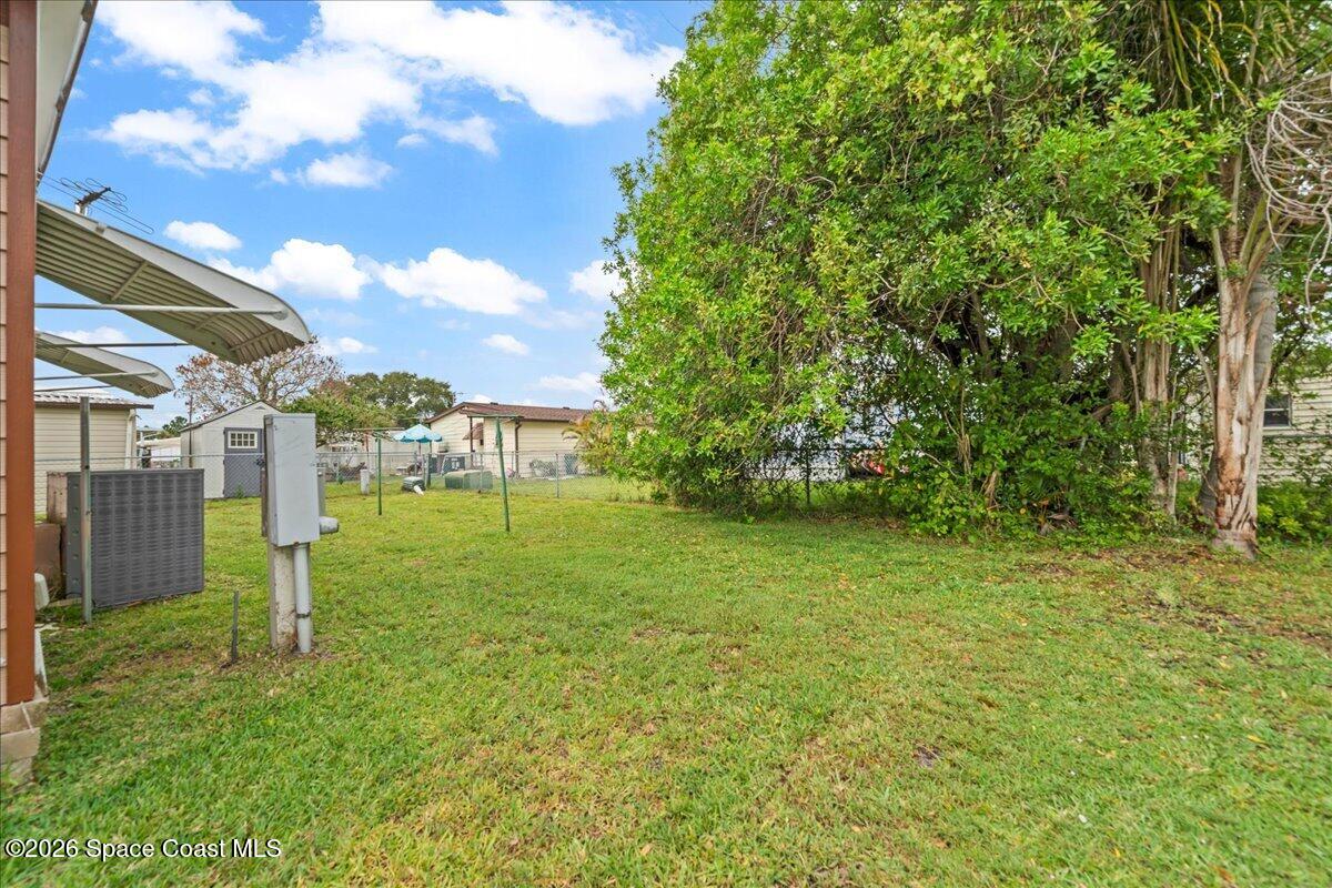 1740 Seagrape Street Northeast Palm Bay, FL 32905 - Photo 18 of 33 a view of a park that has a tree in it
