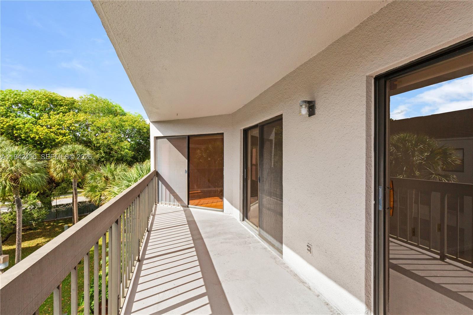 8810 Southwest 132nd Place, Unit 403DN Miami, FL 33186 - Photo 19 of 21 a view of balcony with wooden floor and fence