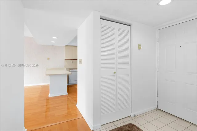 a view of a kitchen with kitchen island and stainless steel appliances
