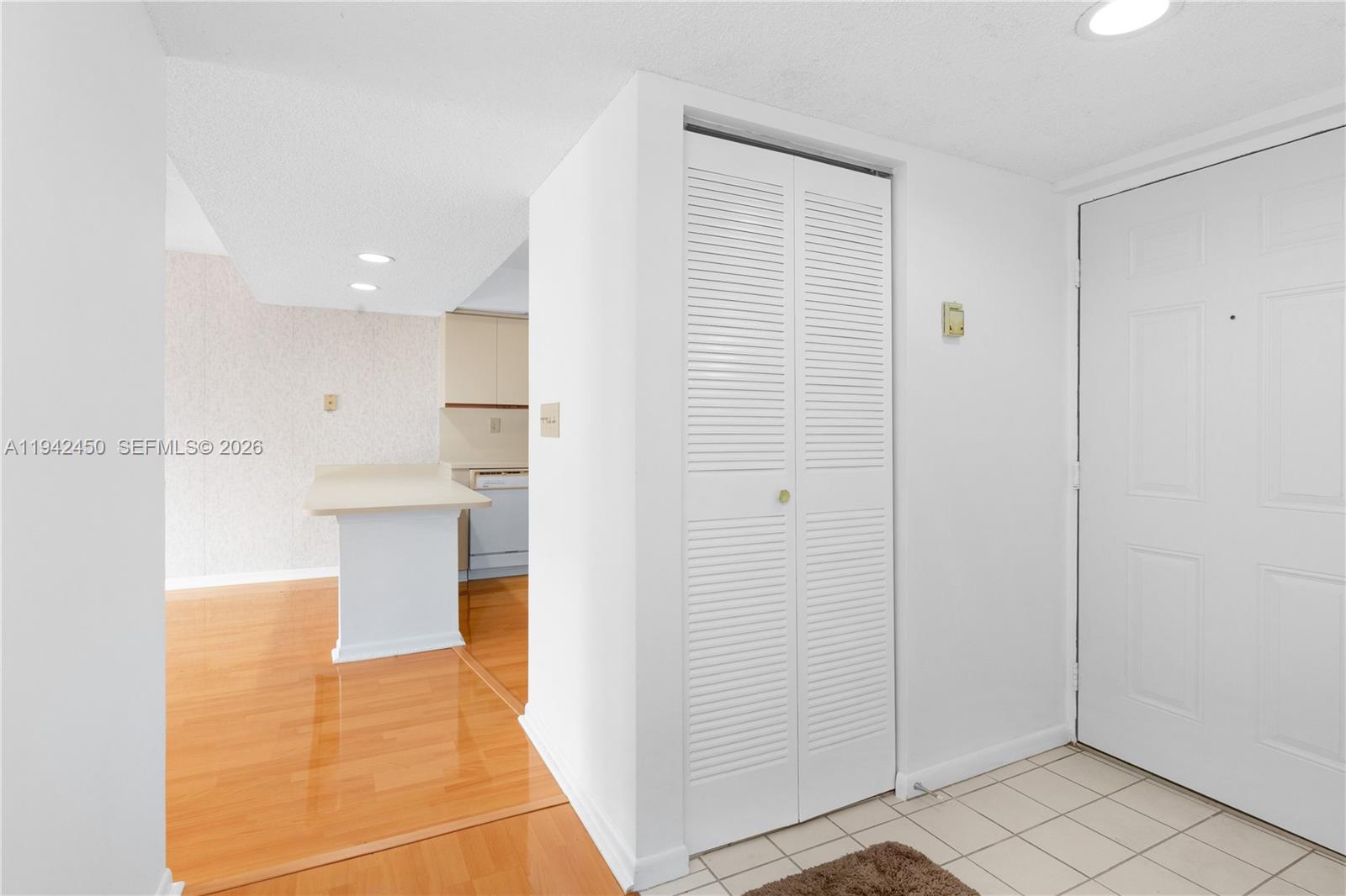 8810 Southwest 132nd Place, Unit 403DN Miami, FL 33186 - Photo 3 of 29 a view of a kitchen with kitchen island and stainless steel appliances