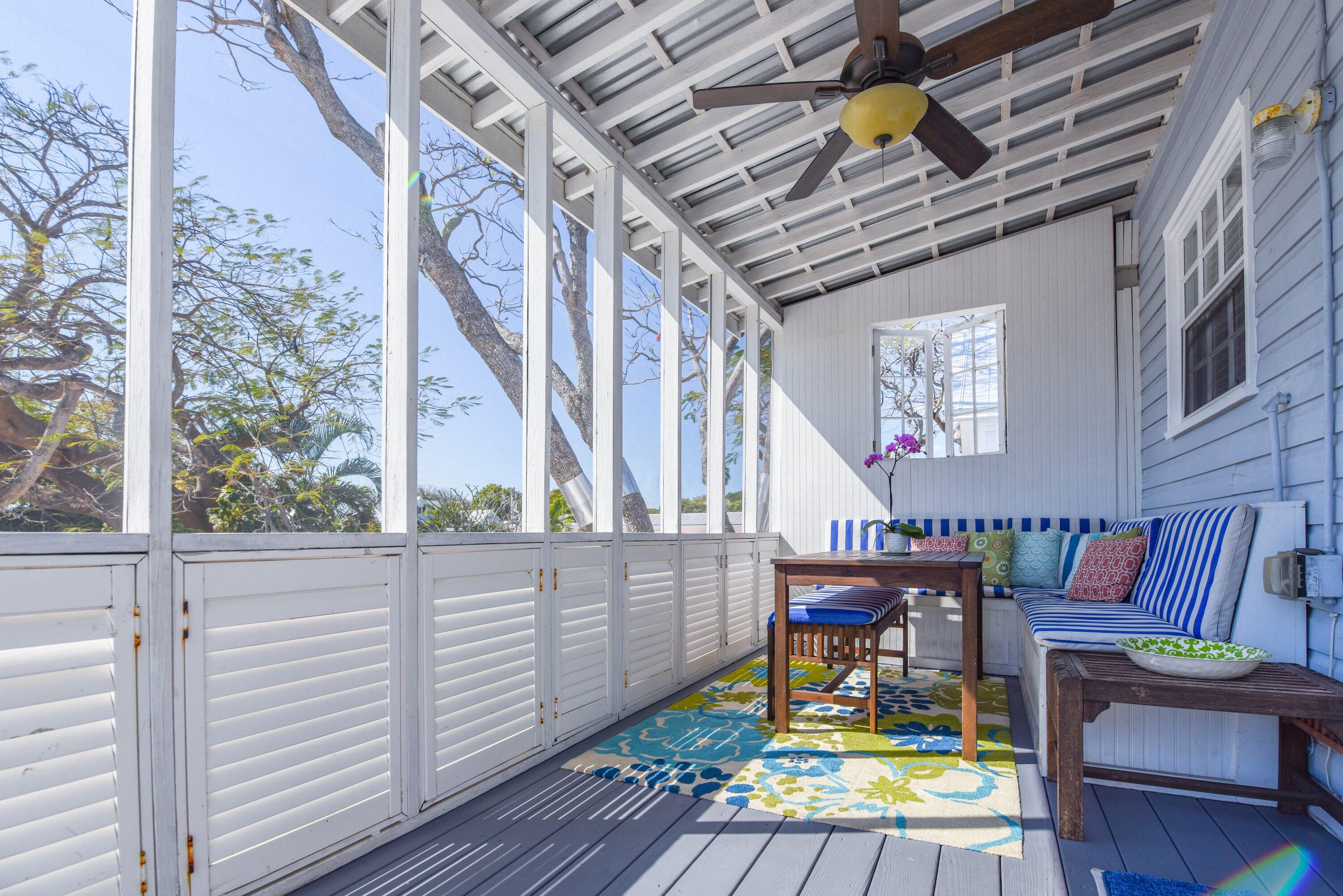 828 White Street, Unit 1 Key West, FL 33040 - Photo 1 of 43 a view of a chair and tables in the balcony