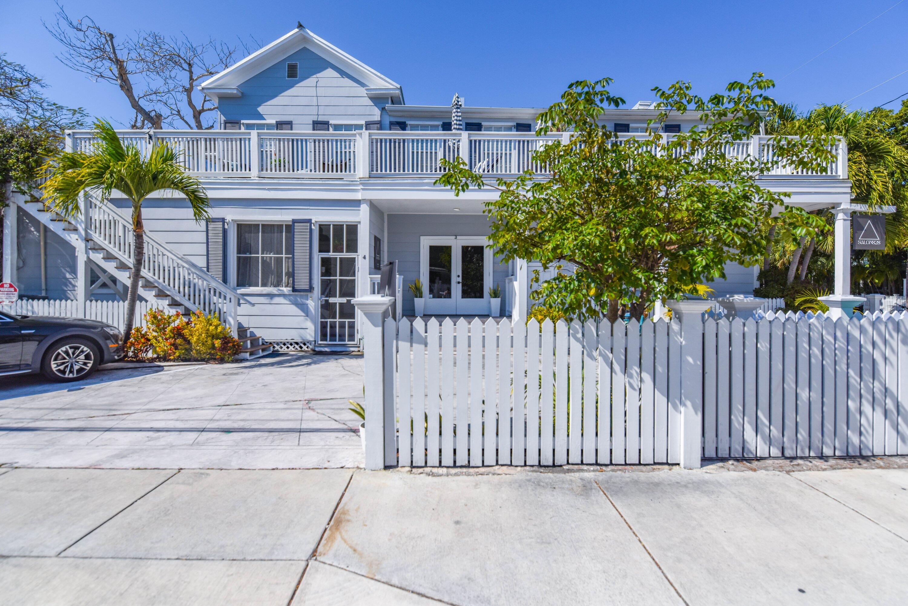 828 White Street, Unit 1 Key West, FL 33040 - Photo 2 of 43 a view of a house with a small yard and wooden fence
