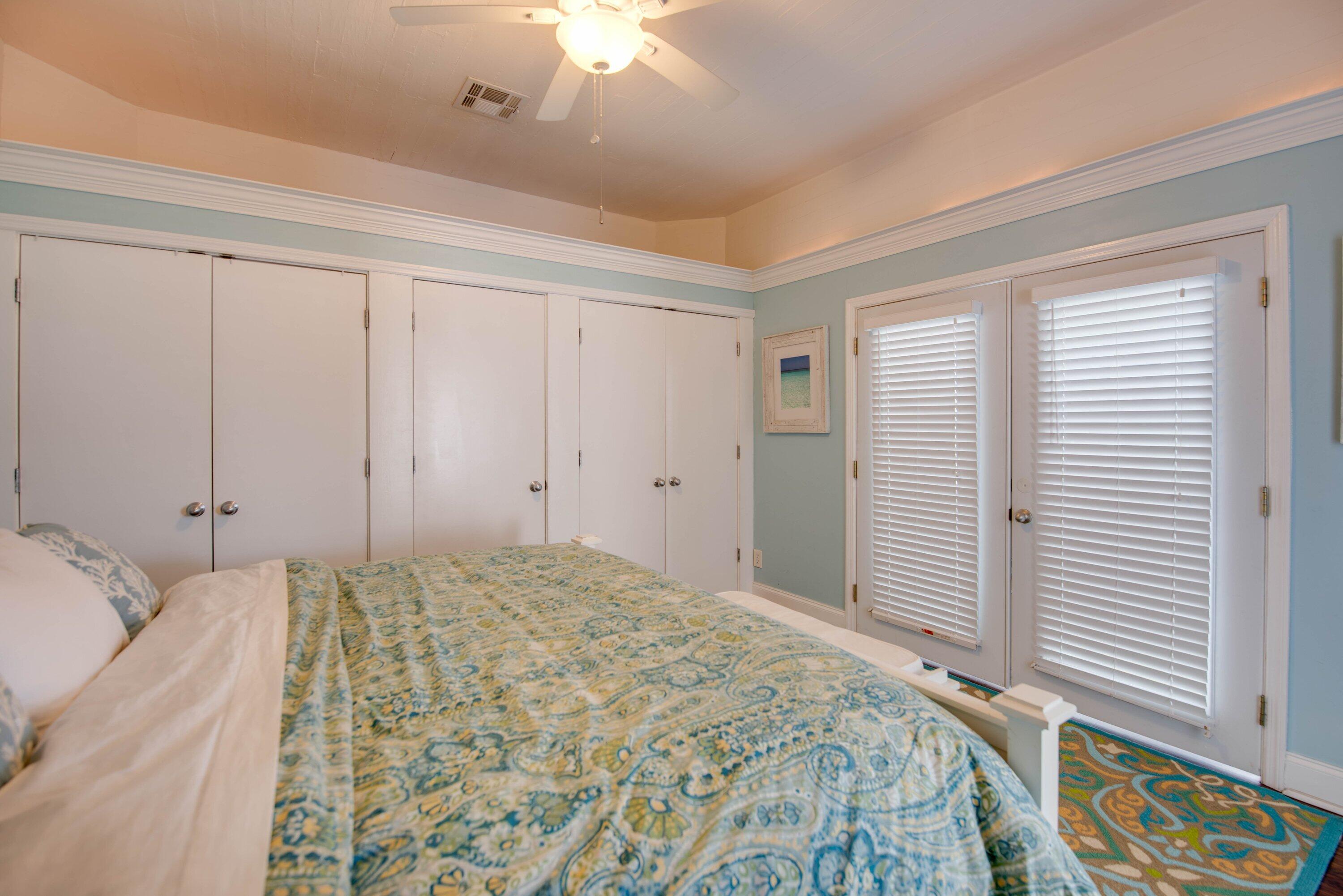 828 White Street, Unit 1 Key West, FL 33040 - Photo 22 of 43 a bedroom with a bed and a chandelier