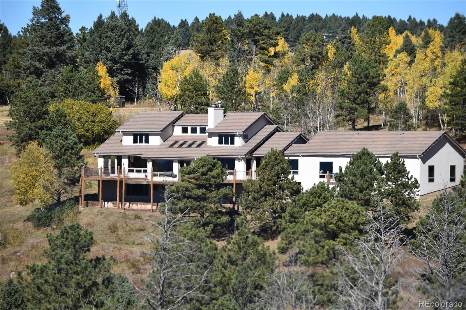 16750 Elk Ridge Road Littleton, CO 80127 - Photo 12 of 25 an aerial view of a house with a yard and trees