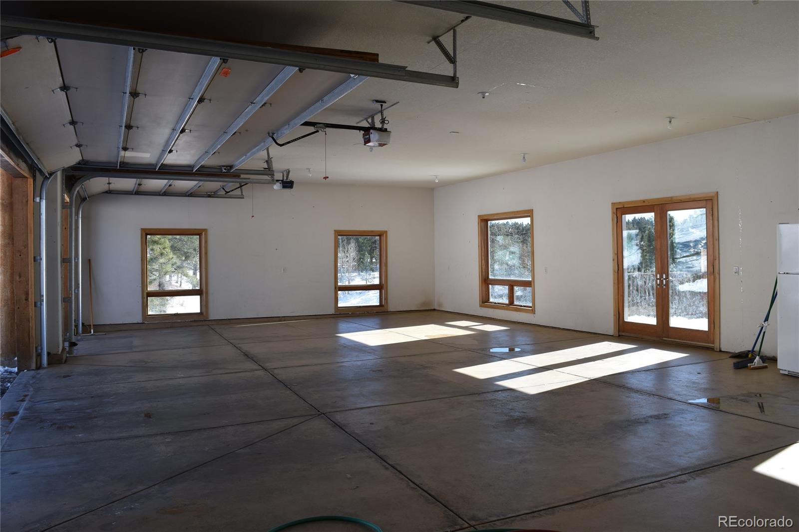 16750 Elk Ridge Road Littleton, CO 80127 - Photo 18 of 25 a view of an empty room with window and wooden floor