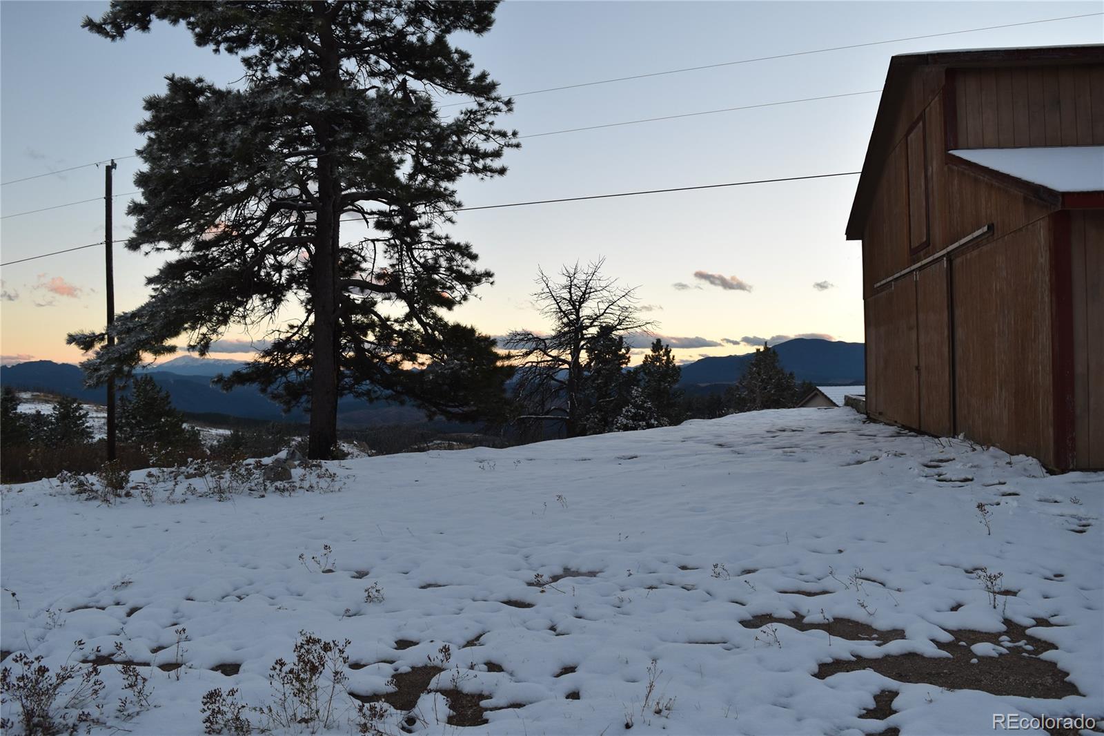 16750 Elk Ridge Road Littleton, CO 80127 - Photo 22 of 25 a view of a dry yard covered with snow in the background