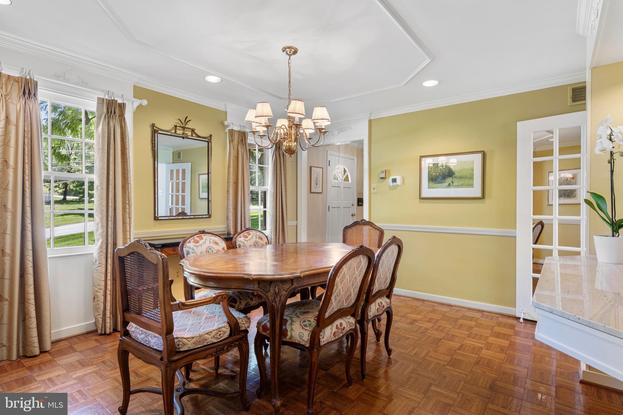 931 Hollow Road Wayne, PA 19087 - Photo 12 of 41 a dining room with furniture a chandelier and wooden floor