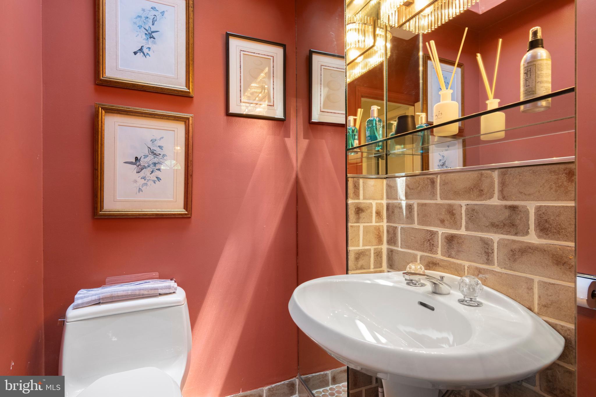 931 Hollow Road Wayne, PA 19087 - Photo 21 of 41 a bathroom with a toilet sink and mirror