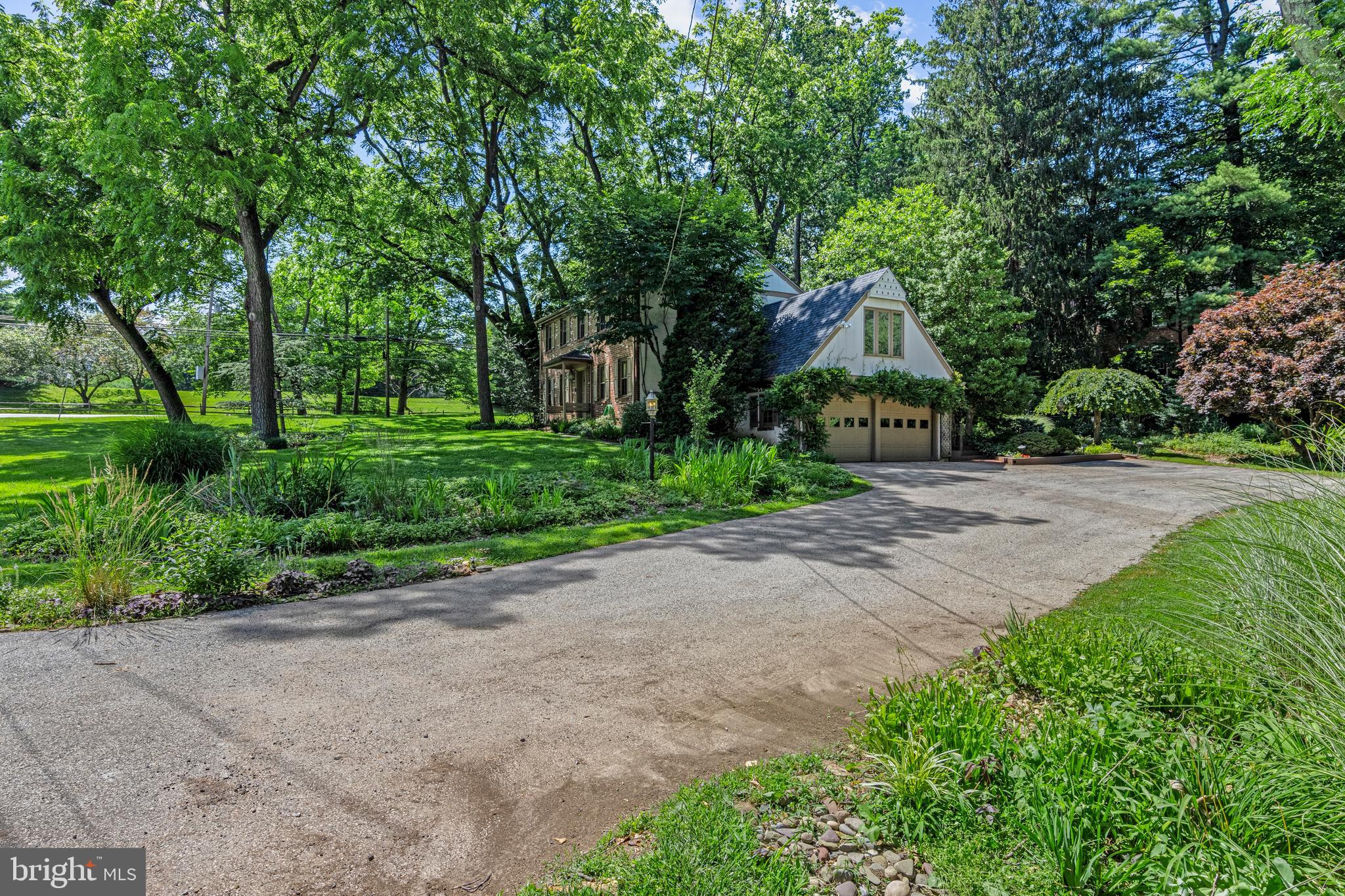 931 Hollow Road Wayne, PA 19087 - Photo 39 of 41 a front view of a house with a yard and shrubs