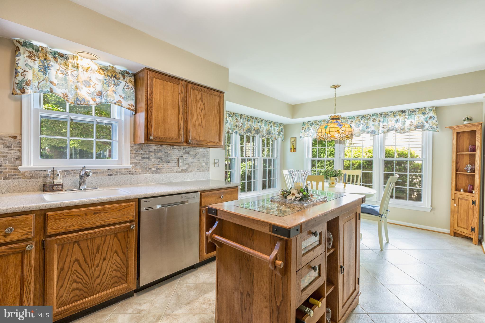 2102 Salt Kettle Way Reston, VA 20191 - Photo 6 of 22 a kitchen with a stove a sink a refrigerator and a granite countertops with window