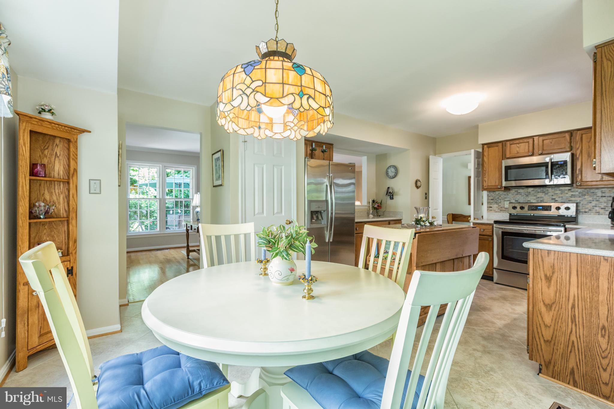 2102 Salt Kettle Way Reston, VA 20191 - Photo 8 of 22 a view of a dining room with furniture wooden floor and chandelier