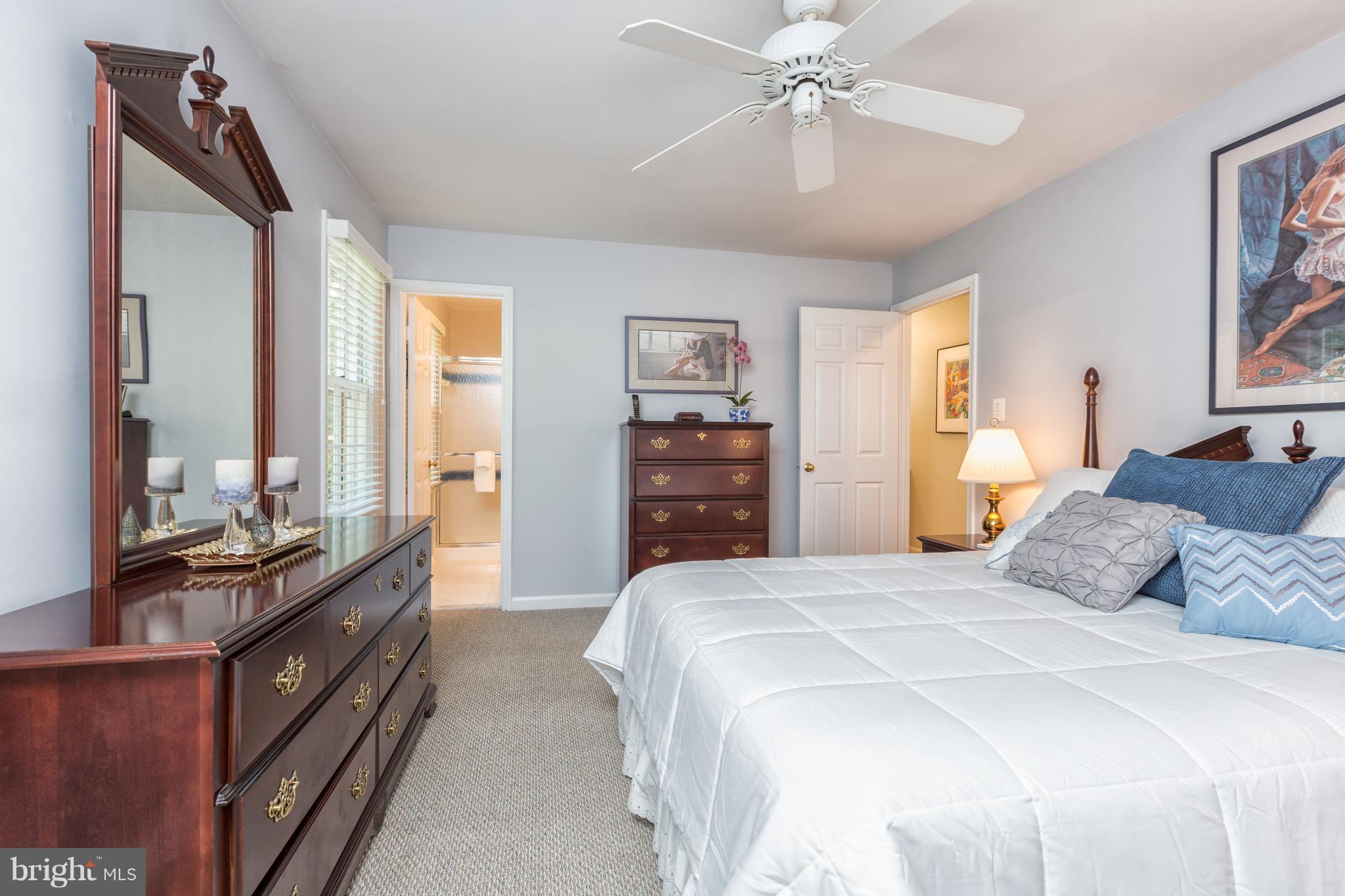 2102 Salt Kettle Way Reston, VA 20191 - Photo 10 of 22 a bedroom with a bed and dresser with mirror