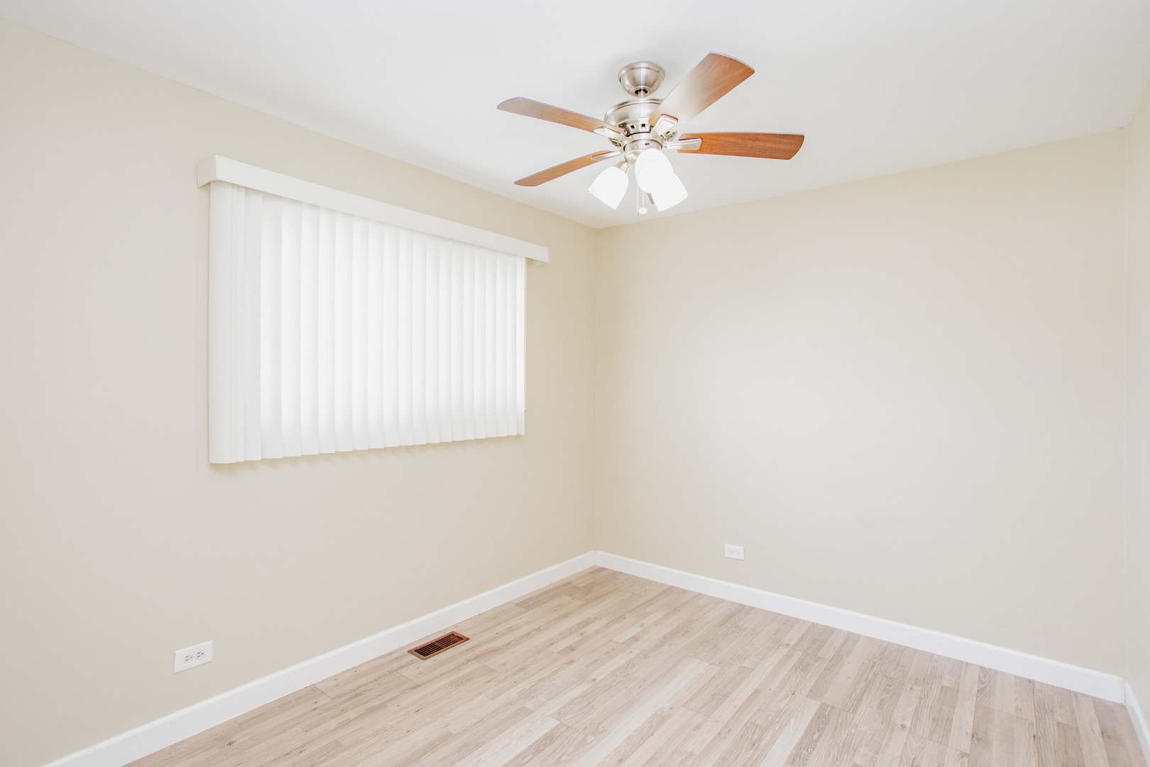 720 Durham Lane Hoffman Estates, IL 60169 - Photo 22 of 32 an empty room with wooden floor and windows