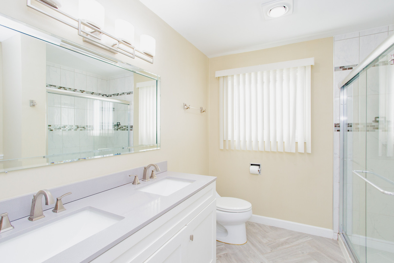 720 Durham Lane Hoffman Estates, IL 60169 - Photo 23 of 32 a bathroom with a granite countertop sink toilet a large mirror and shower