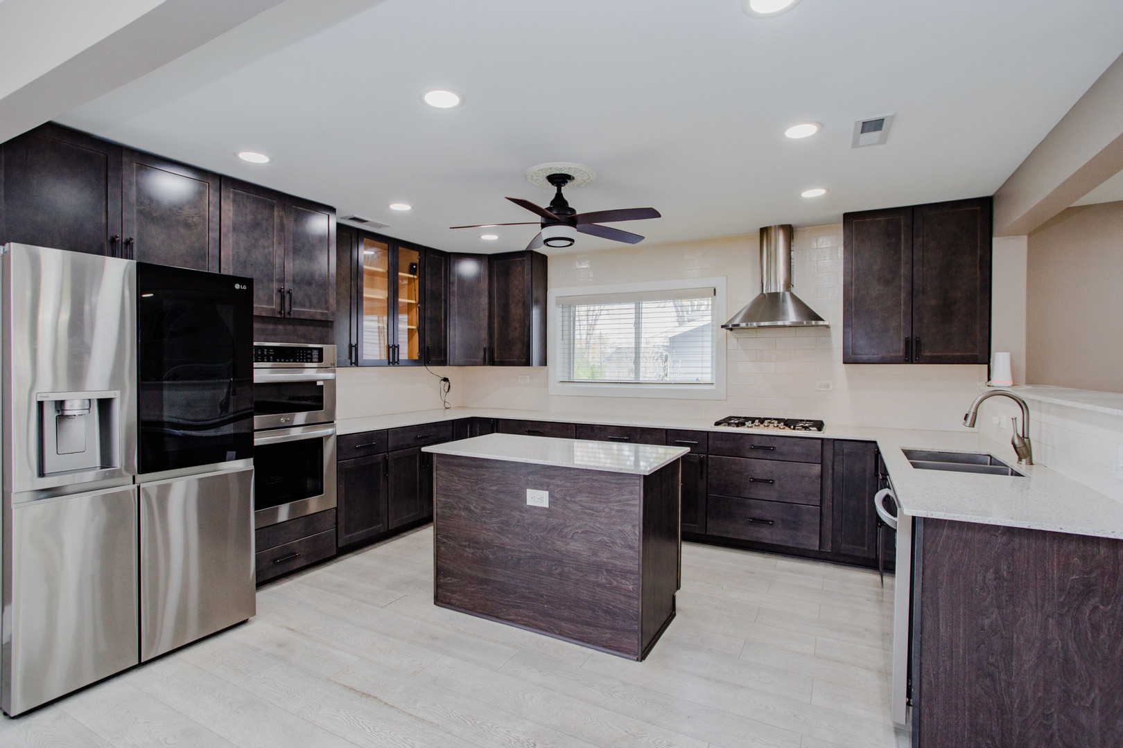 720 Durham Lane Hoffman Estates, IL 60169 - Photo 7 of 32 a kitchen with stainless steel appliances granite countertop a sink stove and refrigerator