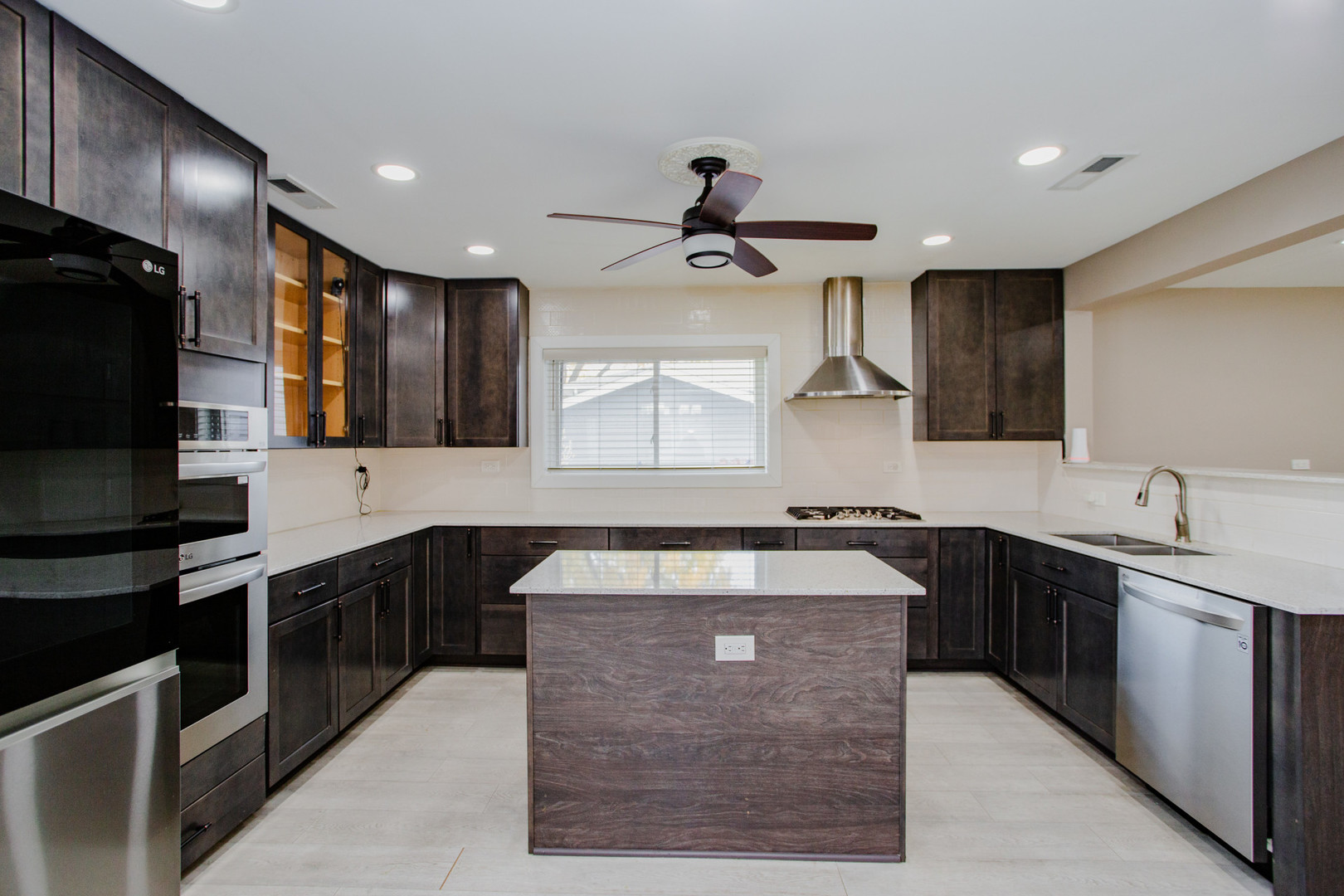 720 Durham Lane Hoffman Estates, IL 60169 - Photo 8 of 32 a kitchen with stainless steel appliances granite countertop a sink stove and refrigerator