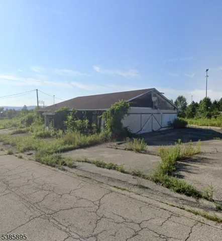 a view of a street with a building in the background