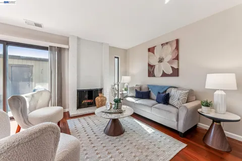 a bedroom with a bed couch and a potted plant