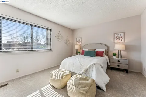 a bedroom with a bed and a potted plant
