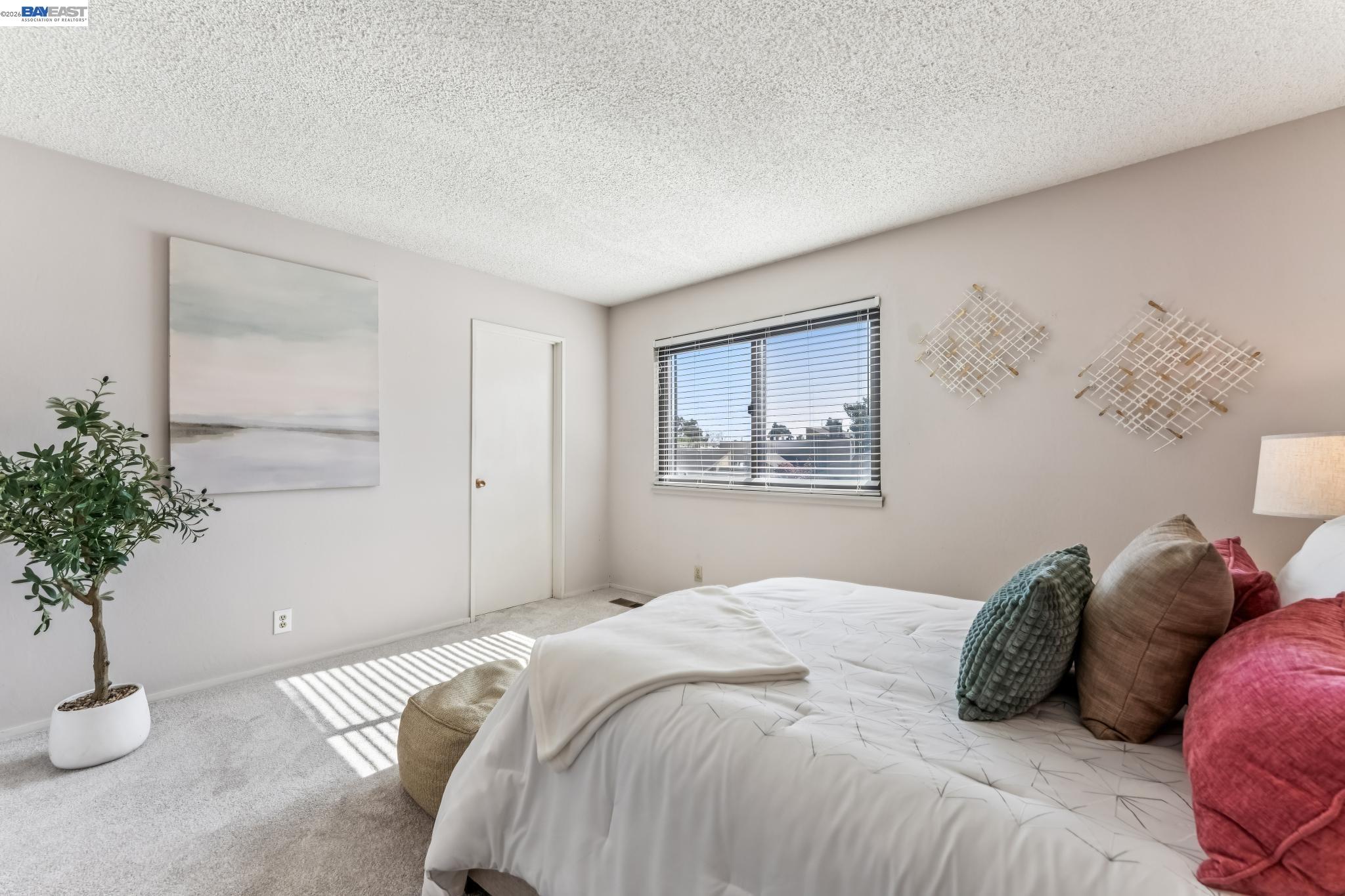 1149 Bismarck Lane Alameda, CA 94502 - Photo 24 of 57 a bedroom with a bed and a potted plant