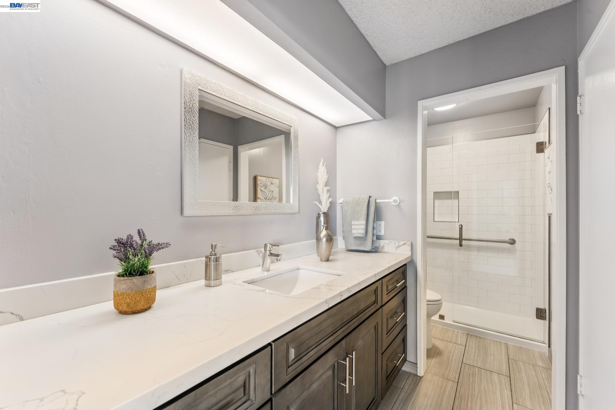 1149 Bismarck Lane Alameda, CA 94502 - Photo 26 of 57 a bathroom with a sink a vanity and a mirror