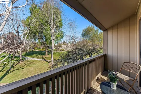 a view of a balcony with chairs