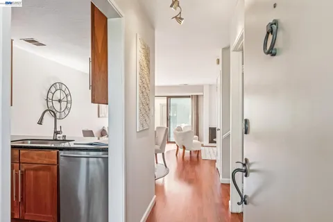 a kitchen with stainless steel appliances granite countertop a stove top oven a sink and dishwasher