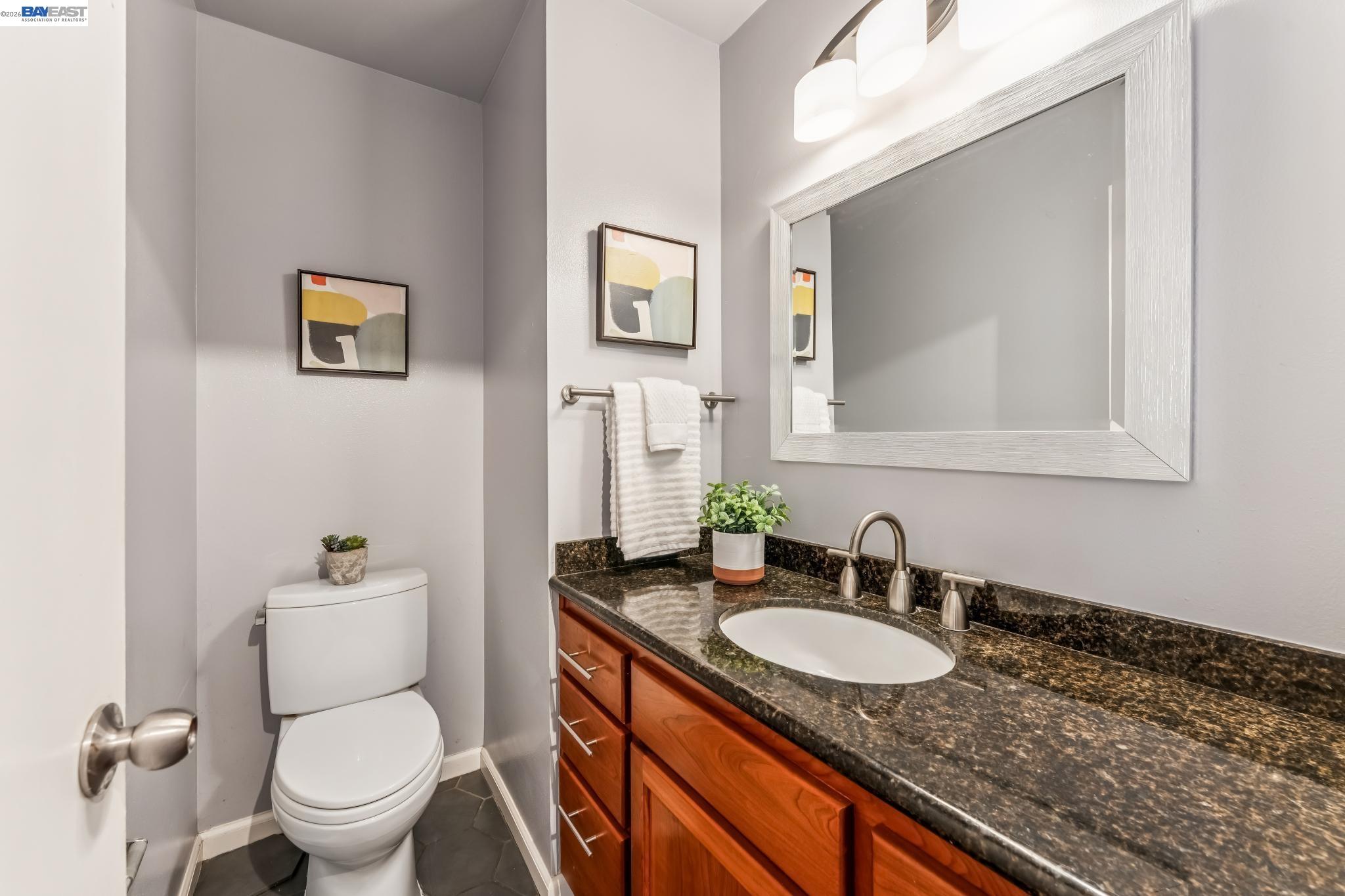 1149 Bismarck Lane Alameda, CA 94502 - Photo 9 of 57 a bathroom with a granite countertop sink and a mirror