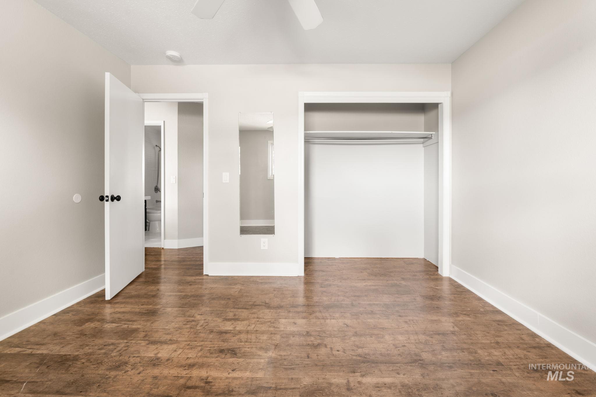 2351 Reservoir Road Clarkston, WA 99403 - Photo 13 of 24 Unfurnished bedroom with dark wood-type flooring, ceiling fan, and a closet