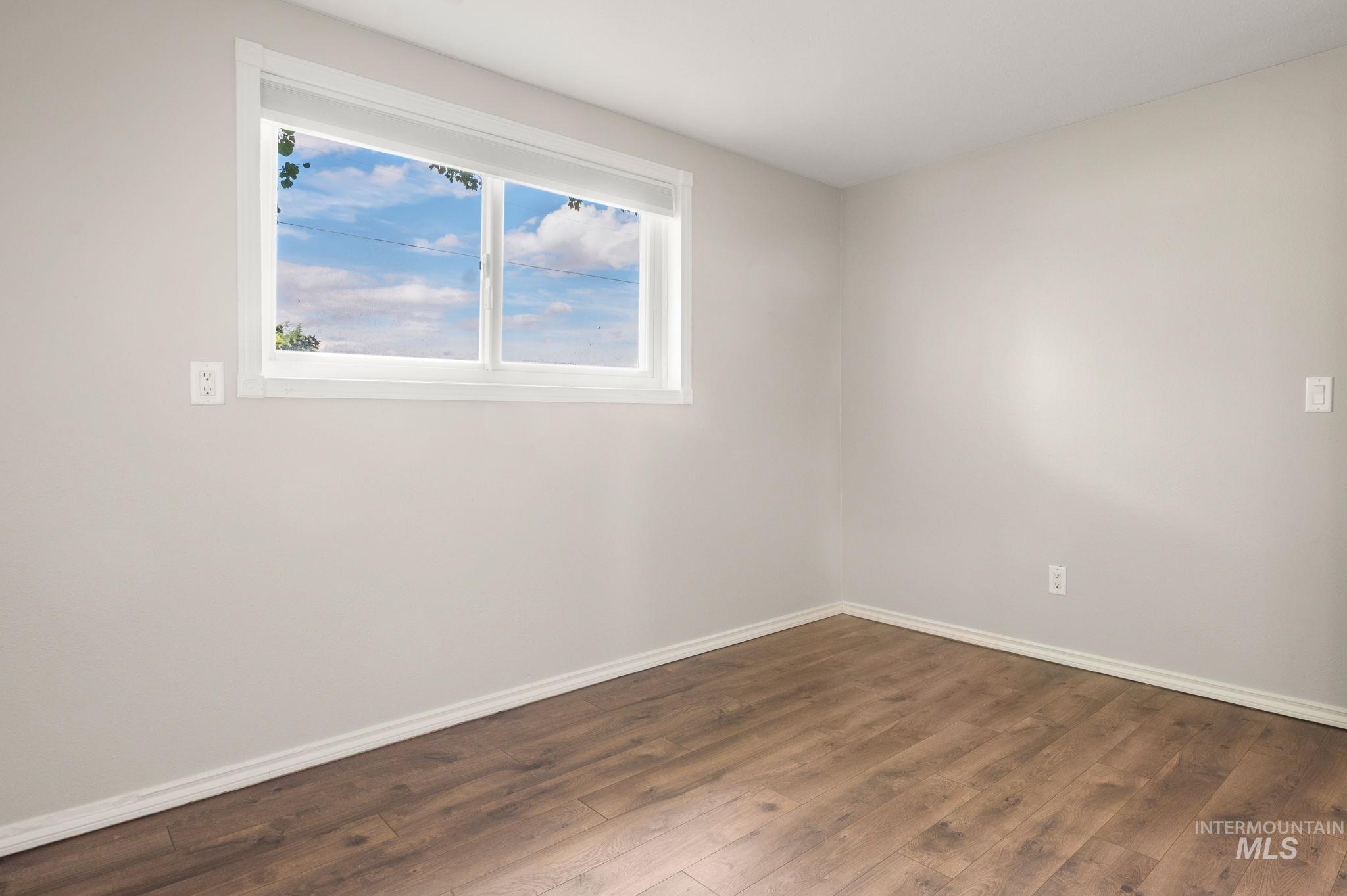 2351 Reservoir Road Clarkston, WA 99403 - Photo 14 of 24 Spare room featuring baseboards and hardwood / wood-style floors