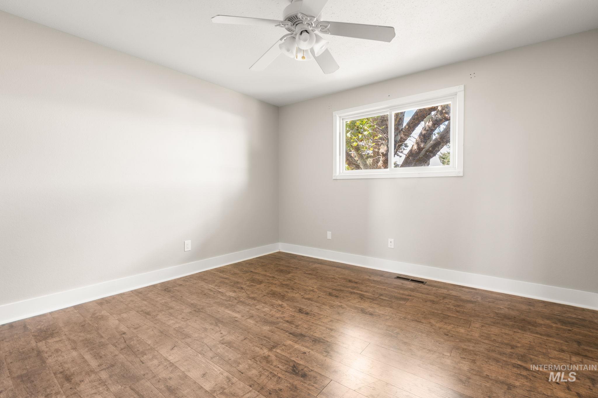 2351 Reservoir Road Clarkston, WA 99403 - Photo 18 of 24 Spare room featuring dark wood finished floors and ceiling fan