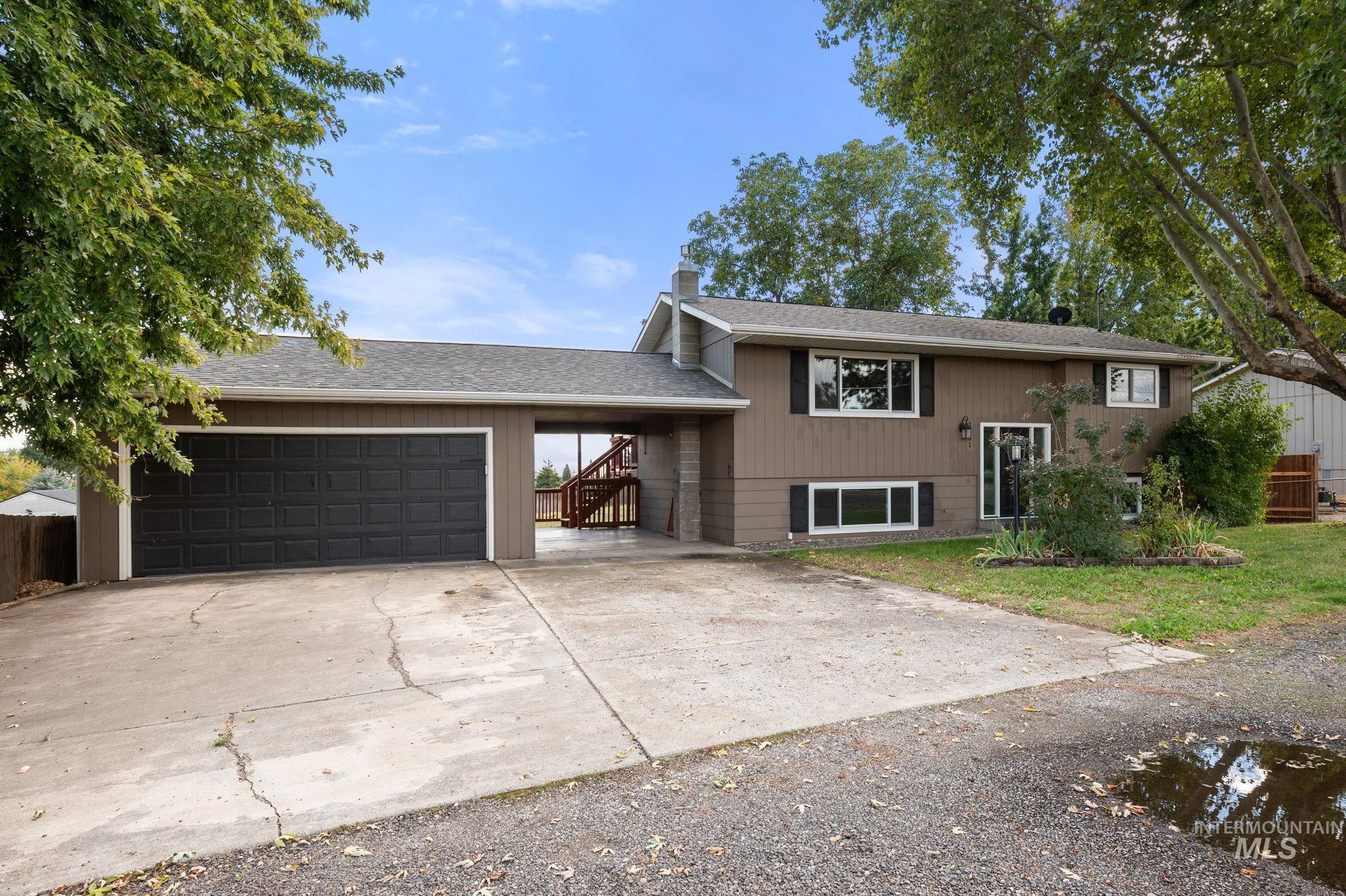 2351 Reservoir Road Clarkston, WA 99403 - Photo 2 of 24 View of front of property featuring a shingled roof, driveway, and a garage