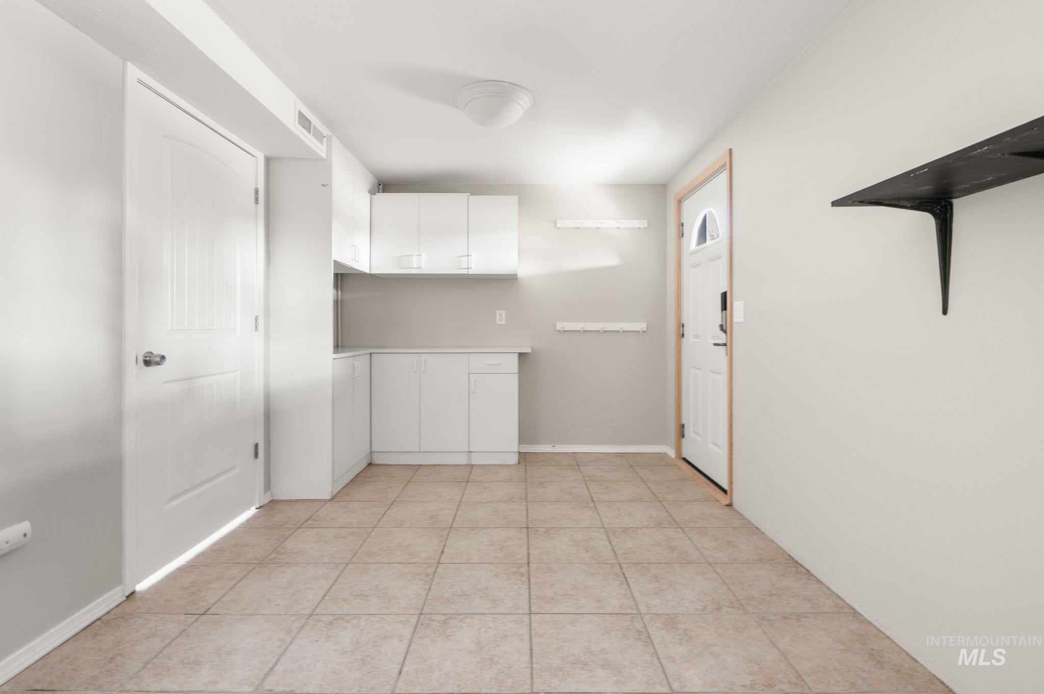 2351 Reservoir Road Clarkston, WA 99403 - Photo 23 of 24 Kitchen featuring white cabinets, light countertops, and light tile patterned flooring