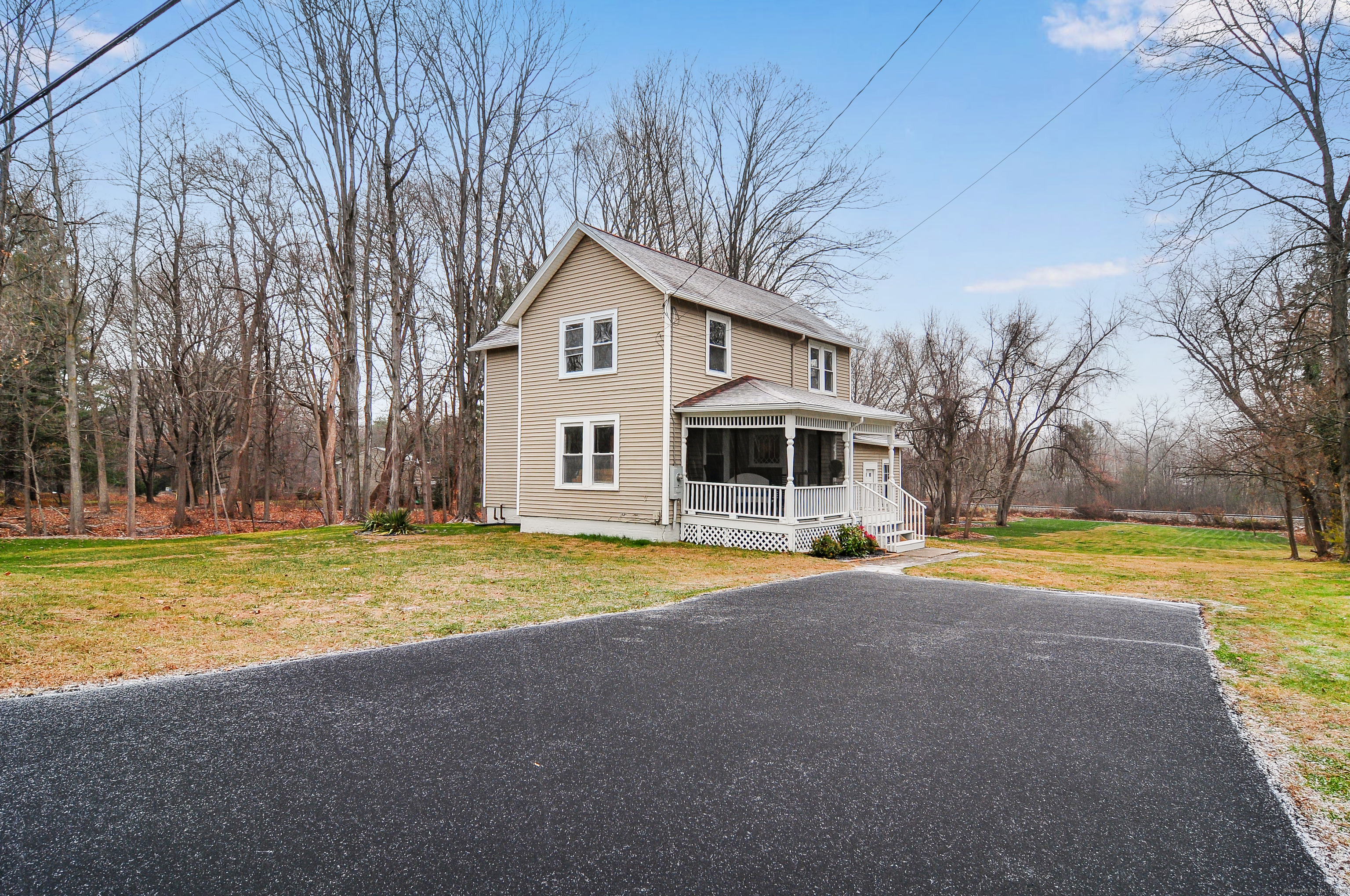 a front view of a house with a yard and trees