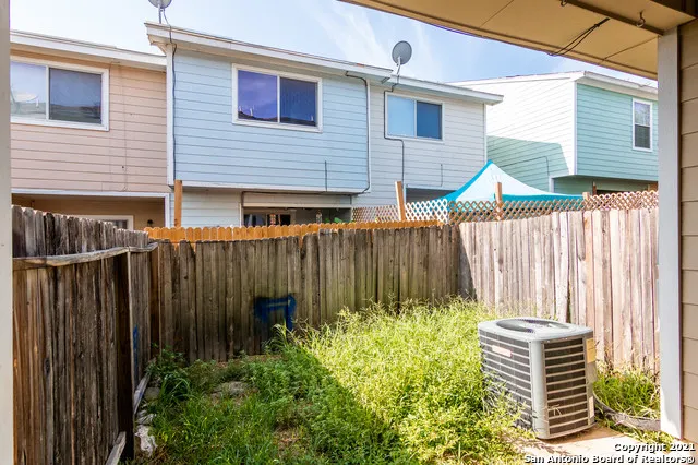 a backyard of a house with outdoor seating