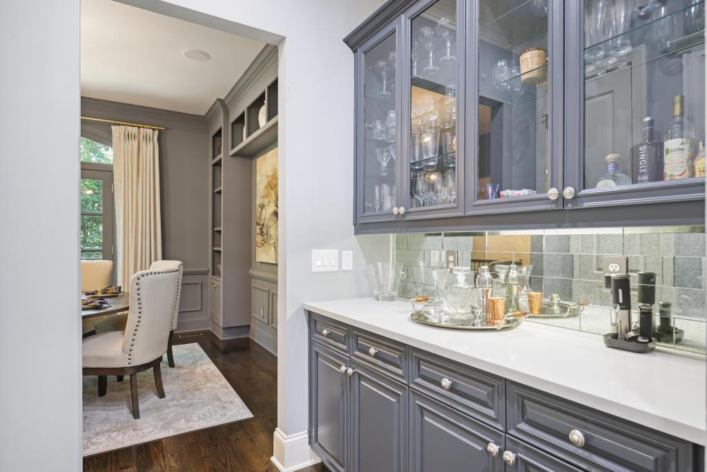 3601 Habersham Road Northwest Atlanta, GA 30305 - Photo 11 of 34 a kitchen with a sink dishwasher a dining table and chairs with wooden floor