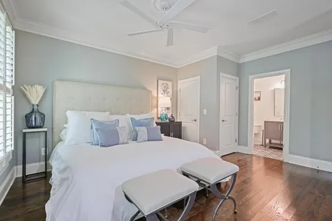 a bed room with a bed a table and chair