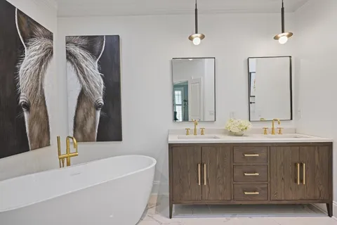 a bathroom with a double vanity sink and a mirror