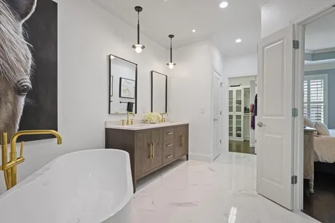a bathroom with a double vanity sink mirror and shower